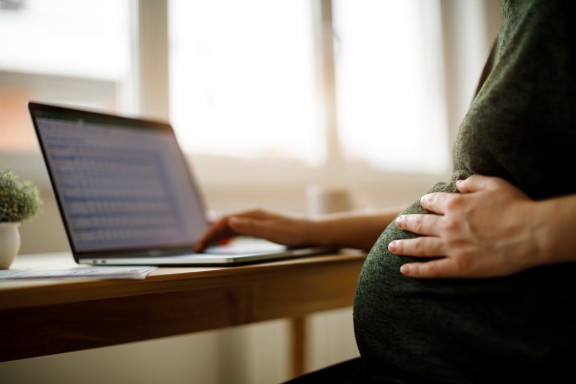 Pregnant woman using laptop