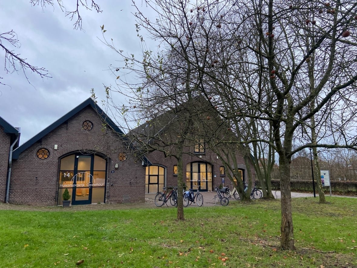 A stone building with bikes parked outside.