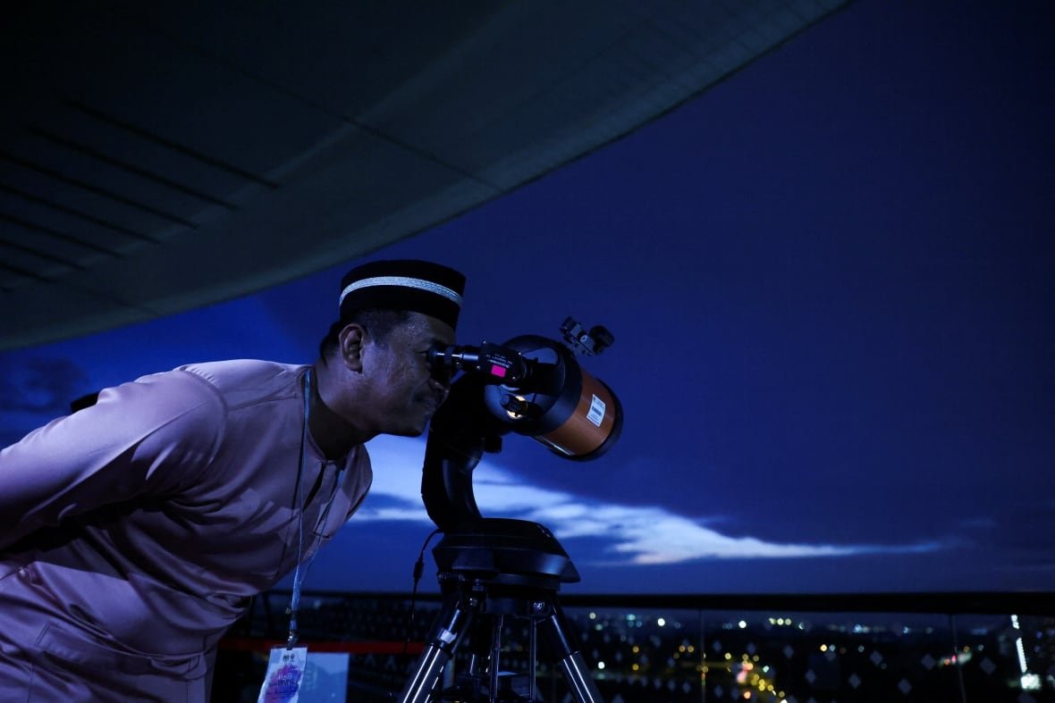 A Muslim looks through a theodolite to perform 'rukyah,' the sighting of the new moon which signals the start of the holy month of Ramadan