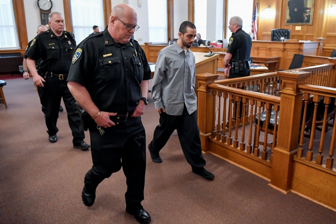 Hadi Matar, second from right, is led out of Chautauqua County court after the guilty verdict in the August 2022 knife attack of author Salman Rushdie.