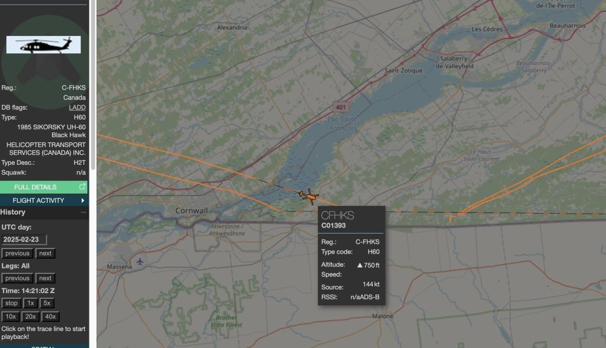 A computer screen shows a flight path over land and a river, and other data.