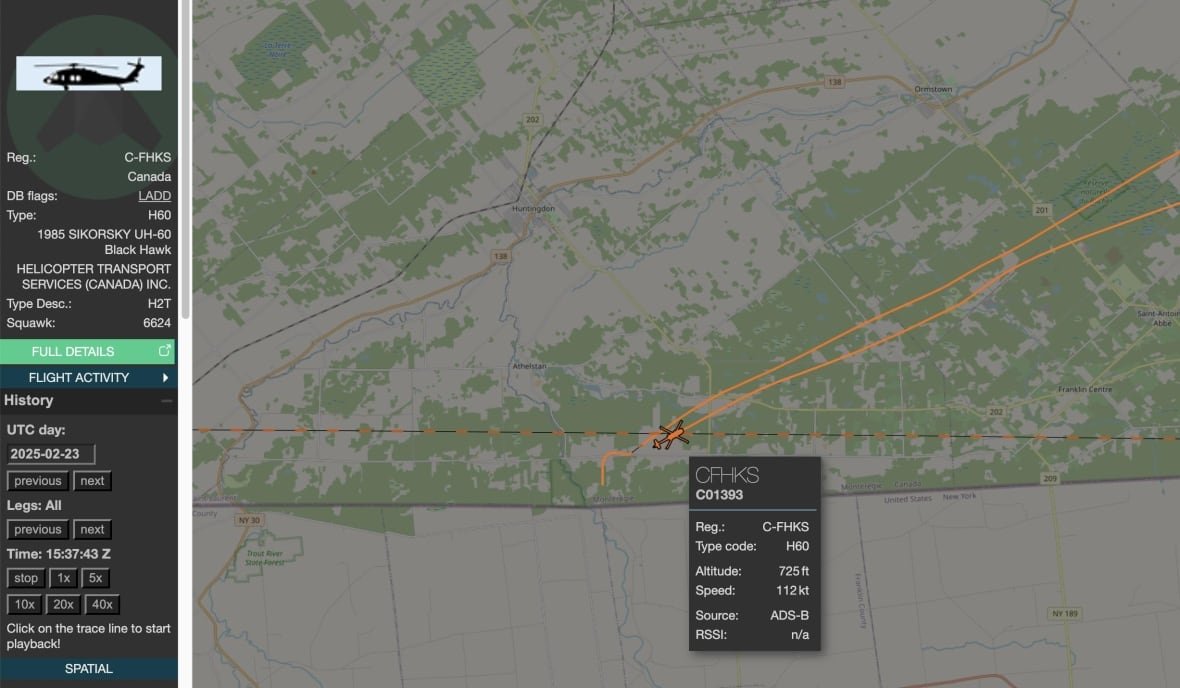 A computer screen shows a flight path over land and a river, and other data.