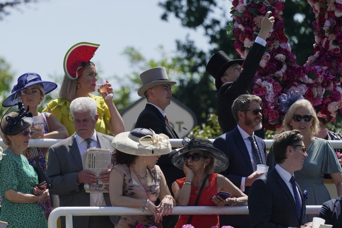britain-royal-ascot People in fancy dress and hats stand outdoors