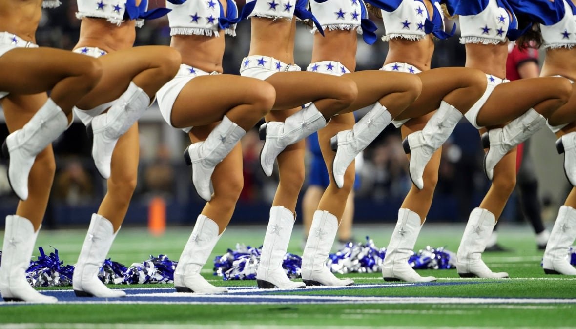 buccanneers-cowboys-football A line of cheerleaders, visible from the waist down