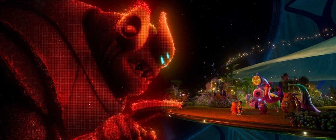 elio-4 An animated image is shown. In it, a hologram of a giant, red alien is shown. He is threateningly leaning over a platform, on which other aliens are standing.