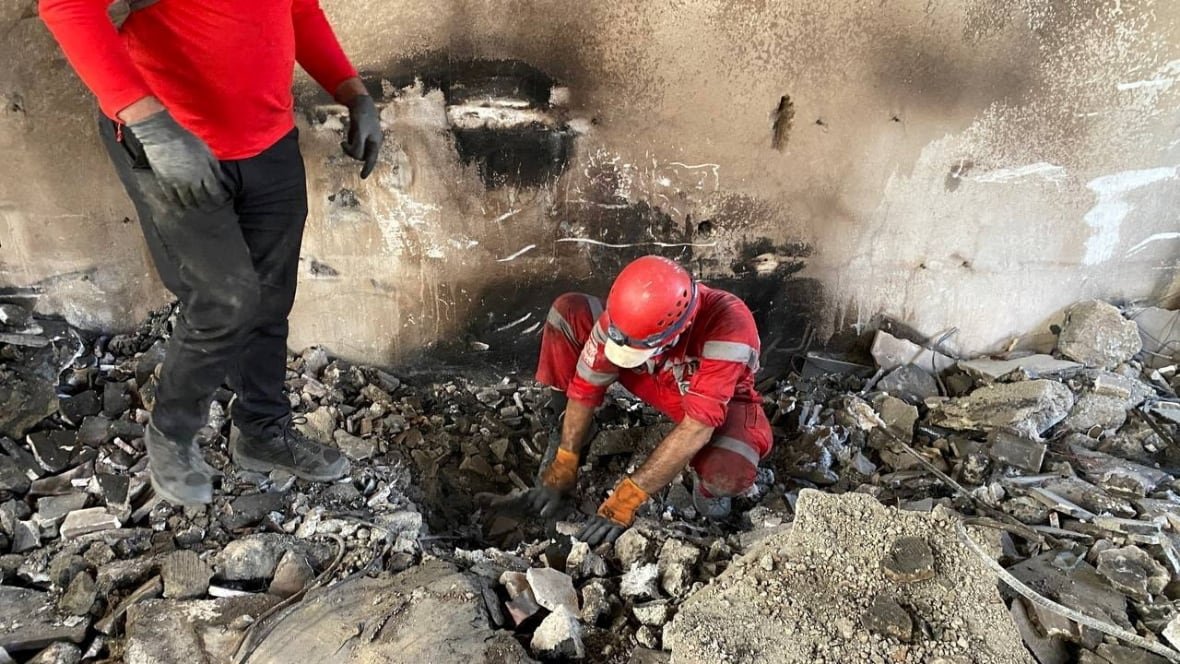 iran-nuclear-red-crescent People search through rubble.