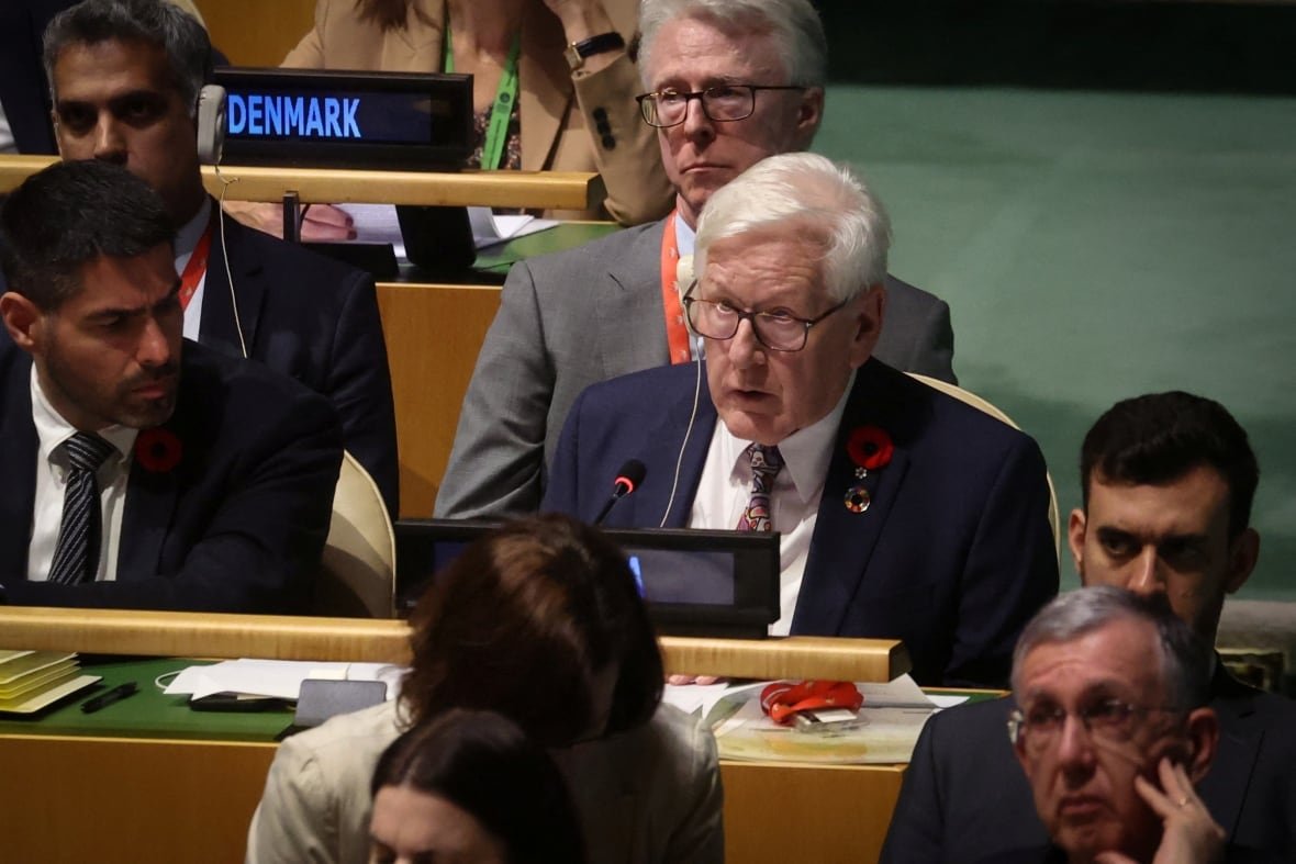 israel-palestinians-un People sit in an assembly room with earpieces.