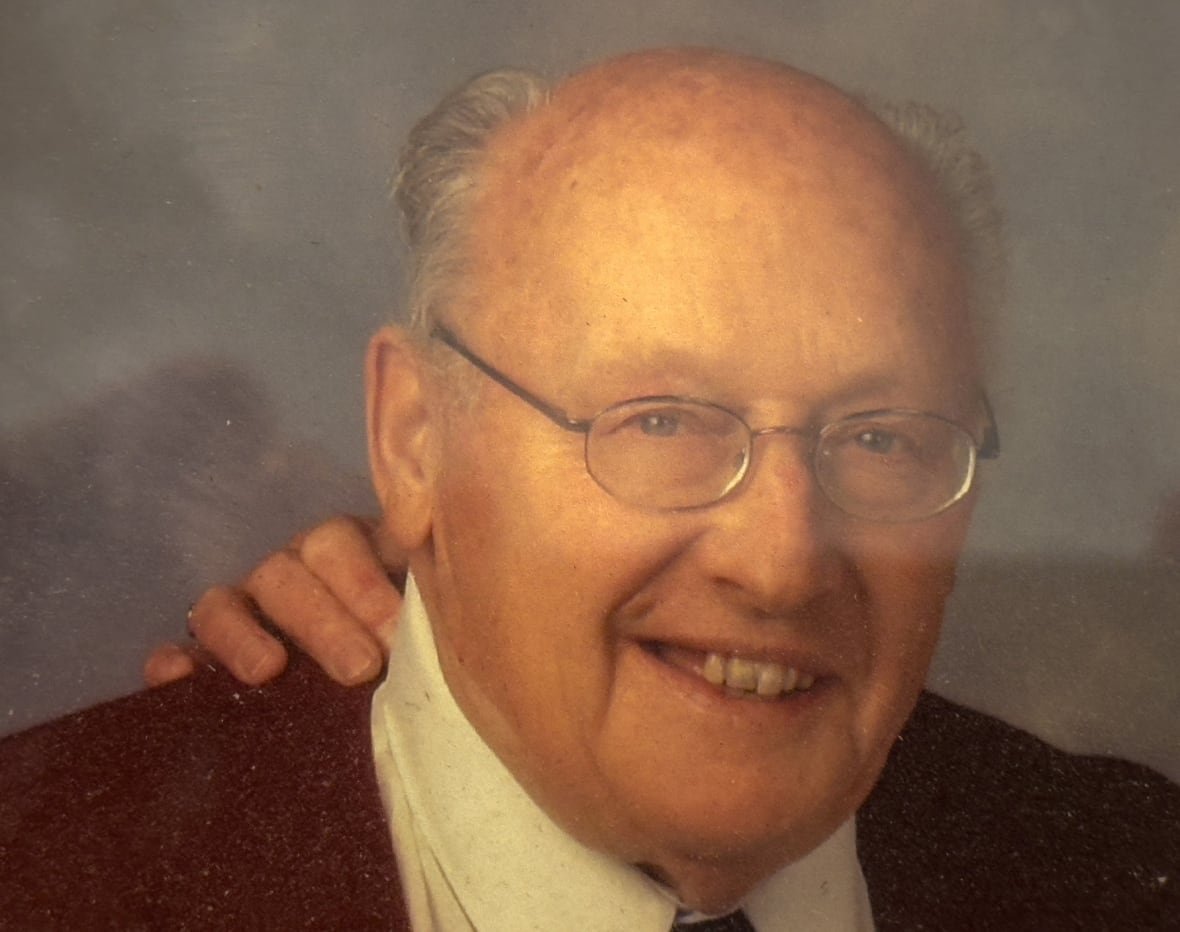 joost-von-weiler A photo of an old photograph of a man, in a suit, with metal glasses.