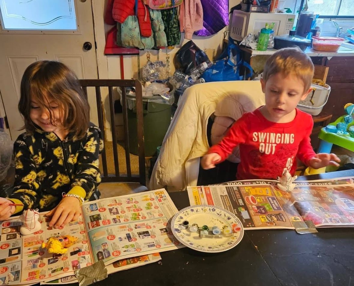 lilly-jack-sullivan-crafts A little girl and boy are seen painting crafts at a table.