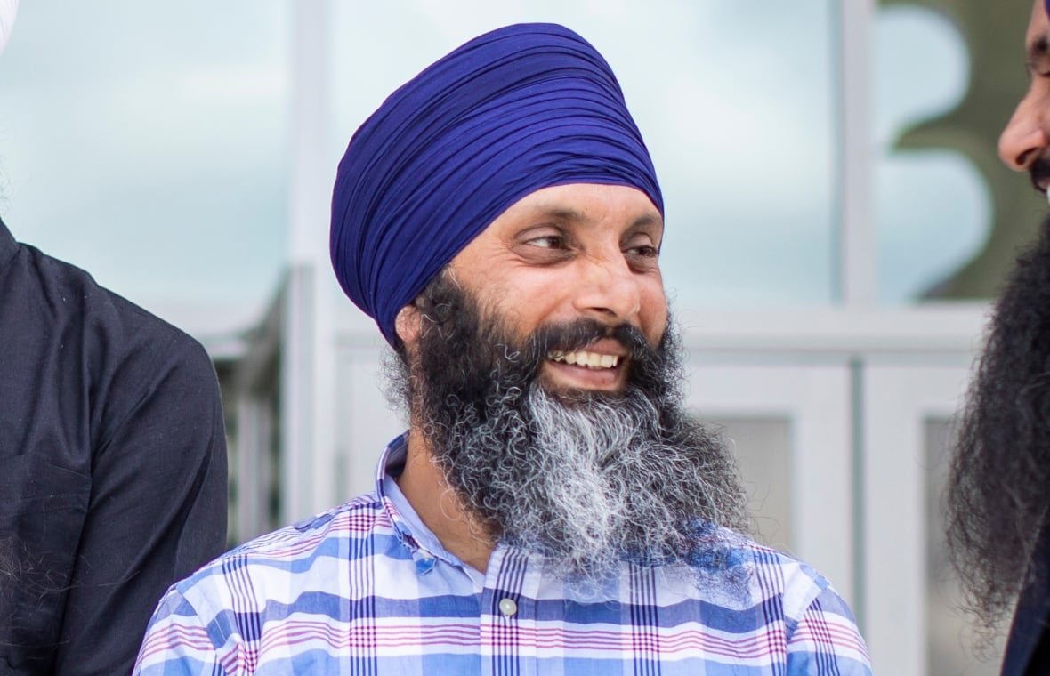 sikh-leaders-back-surrey-police A group of Sikh men speak informally to each other for a posed photograph.
