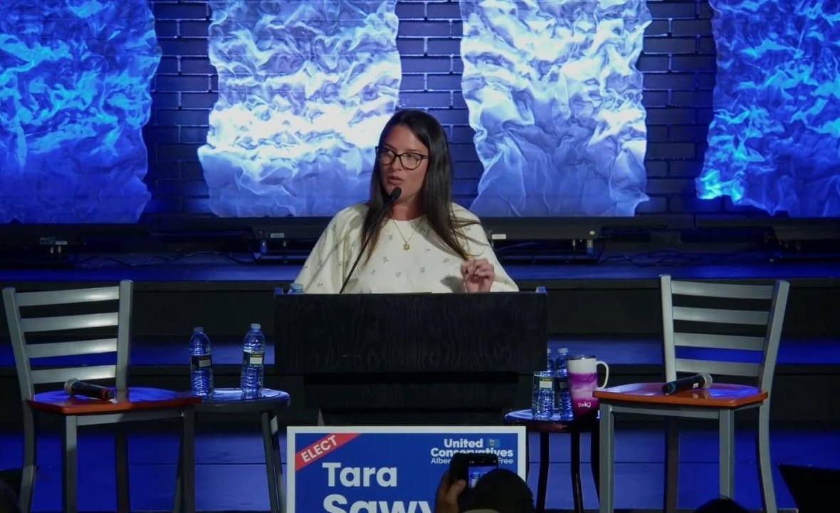 tara-sawyer-ucp a woman at a lectern