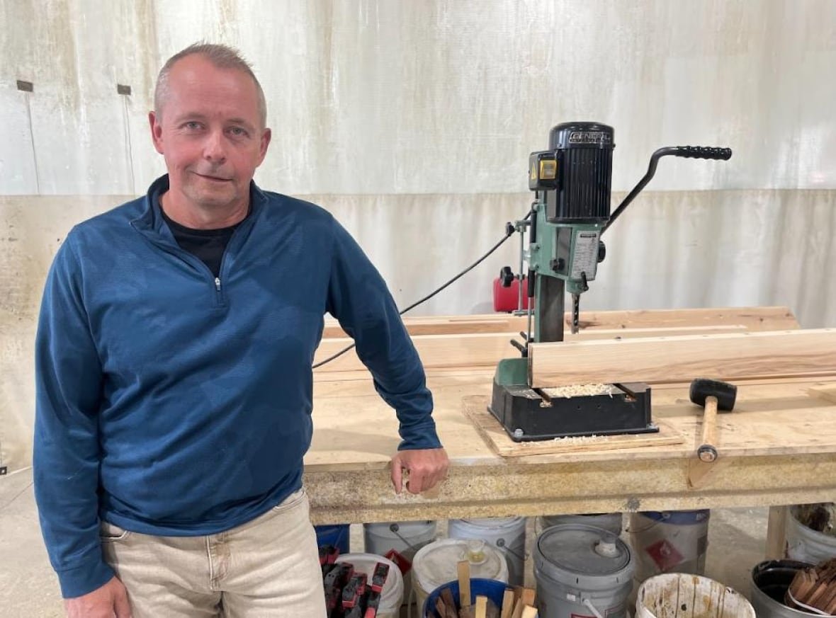 three-hills-mayor-ray-wildeman Man poses at a woodworking table