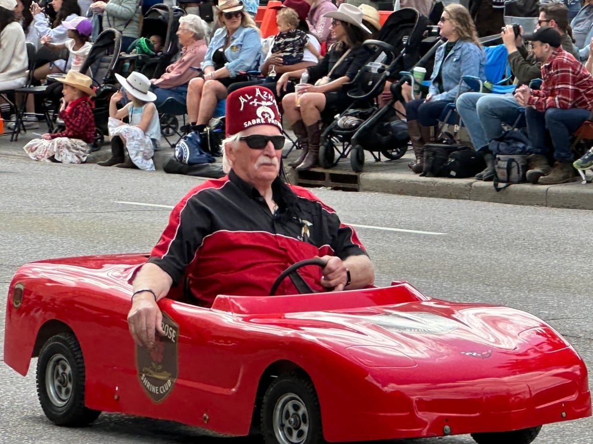 Man in tiny car.