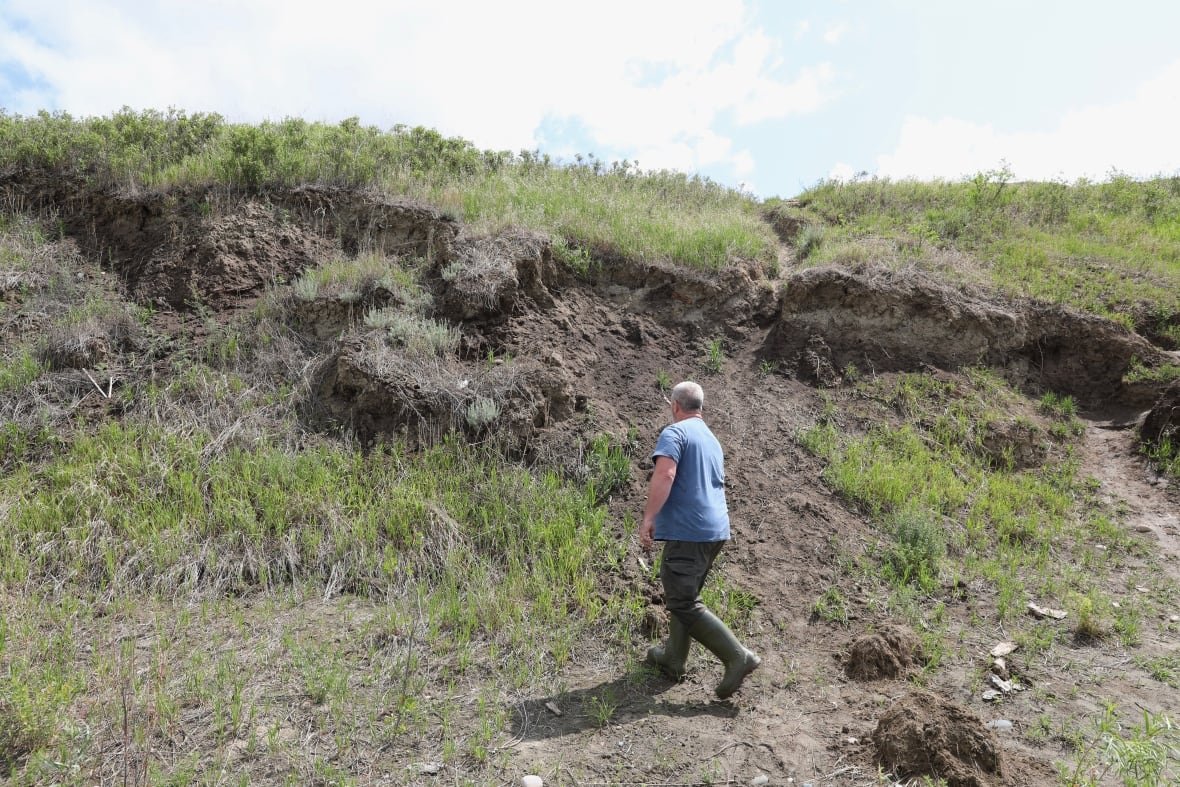 A man walking along a site in Saskatchewan