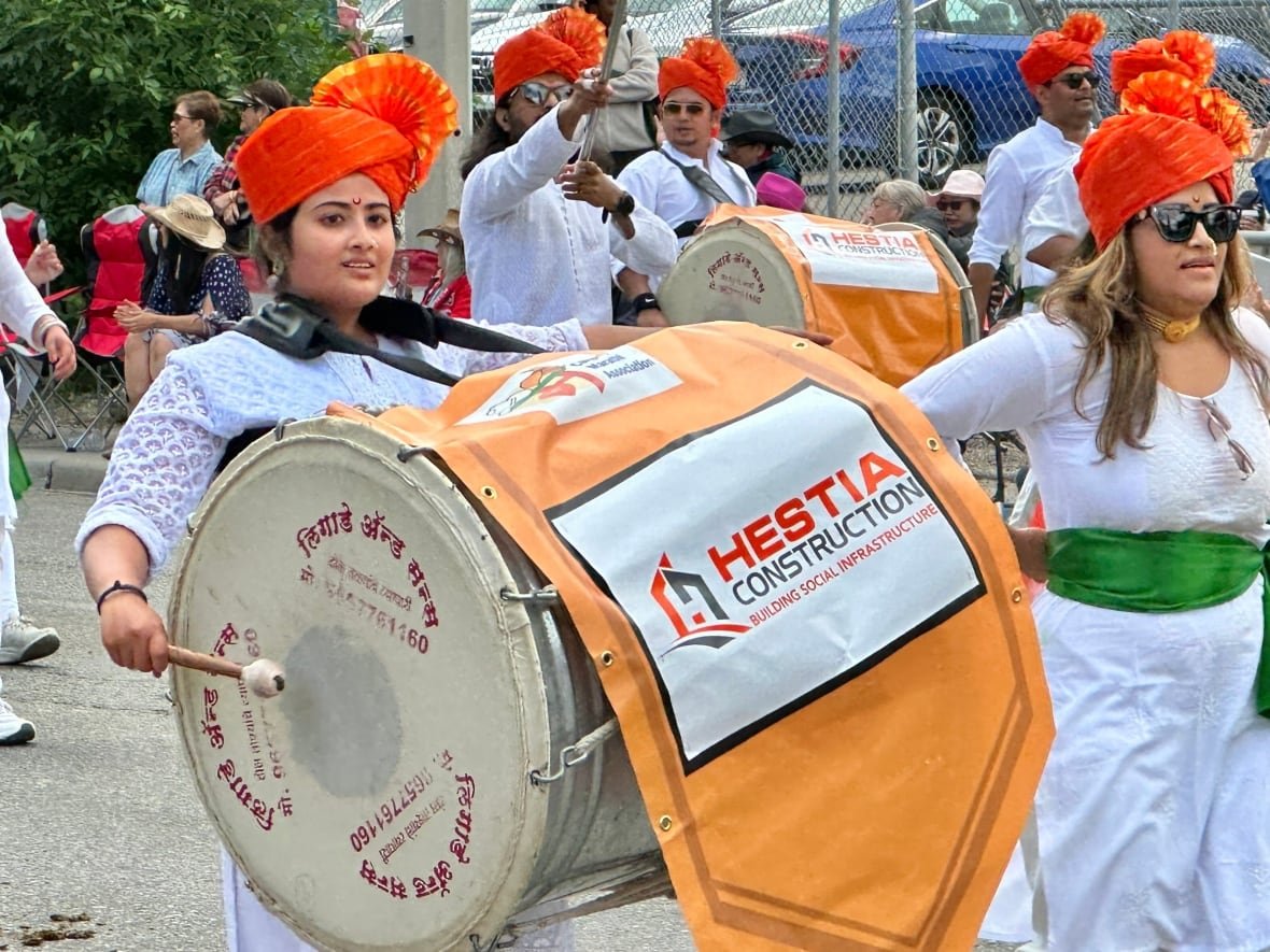 A performer plays the South Asian drum called a 'dhol.'