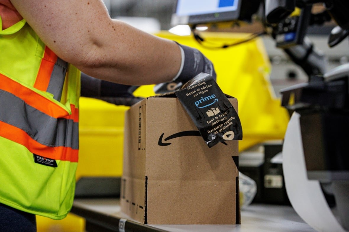 inside-amazon-fulfillment-centre-hamilton An employee handles an Amazon package