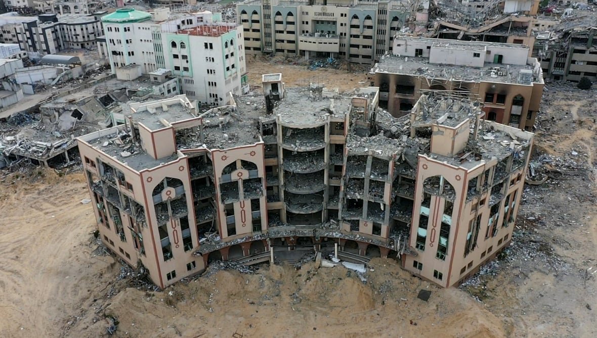israel-palestinians-gaza-ceasefire-drone A building stands ruined in the midst of war.