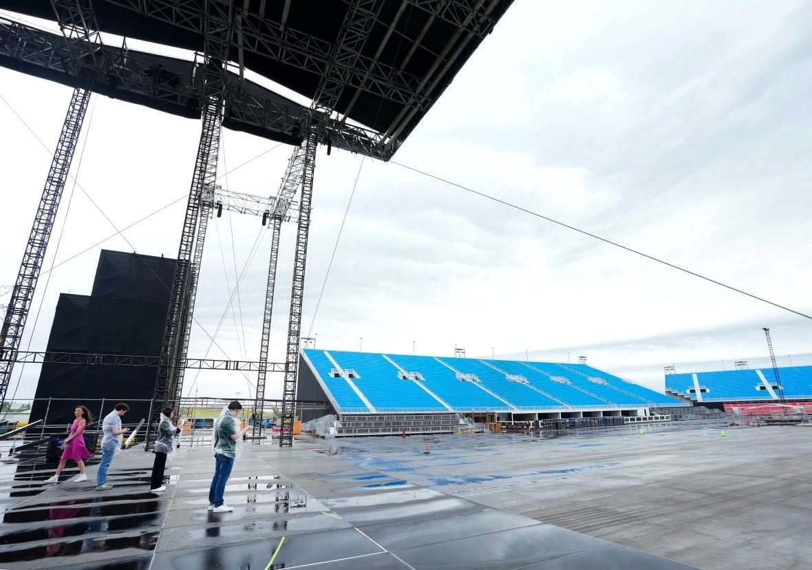 music-rogers-stadium-20250626-2 People stand on a stage.