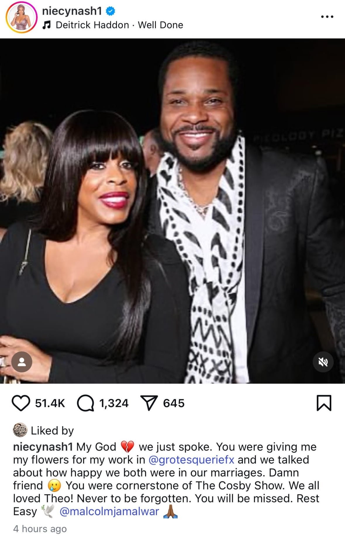 niecy-nash-malcolm-jamal-warner-tribute A woman with long black hair smiles as she stands next to a smiling man with short black hair and a black beard.