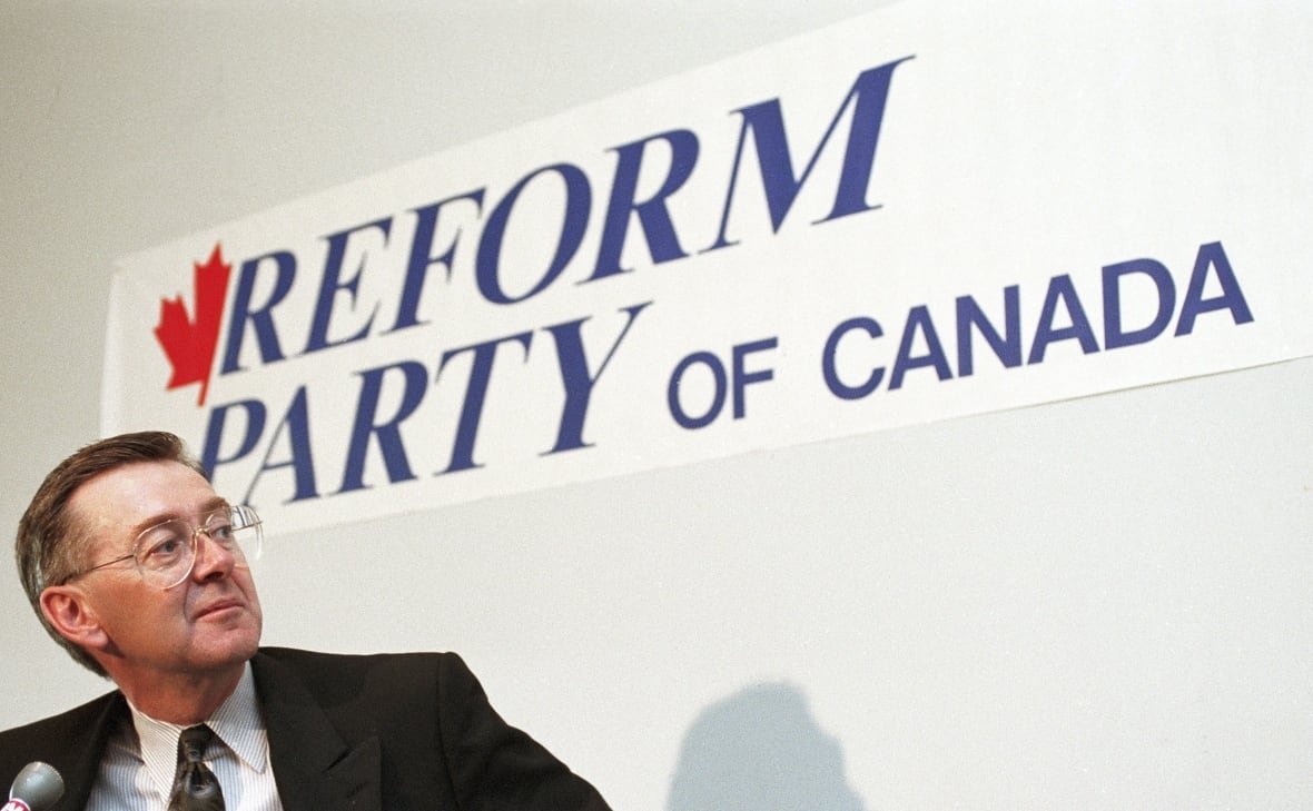 preston-manning Preston Manning pauses in front of a Reform Party of Canada sign during a news conference in Ottawa on Nov. 27, 1991.
