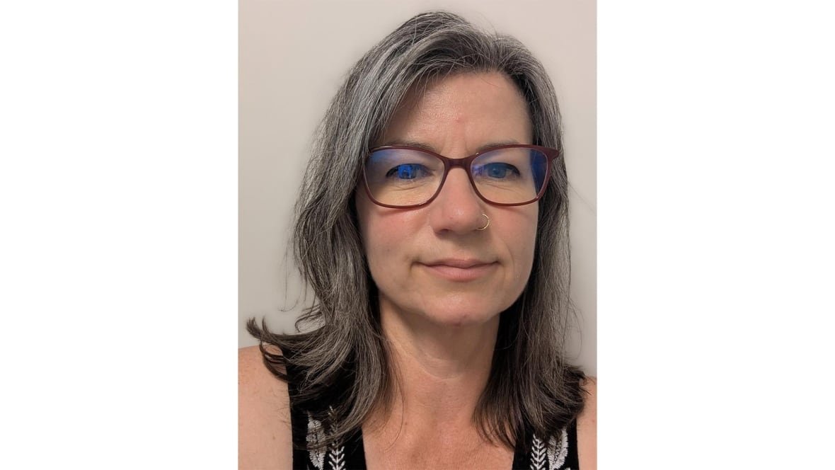 stacey-slager A woman wearing glasses smiles for the camera