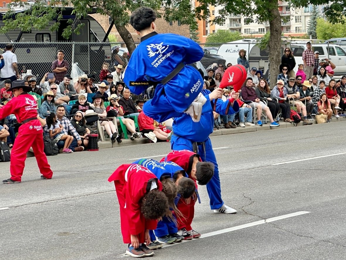 A Taekwondo demonstration captivates onlookers during the parade.