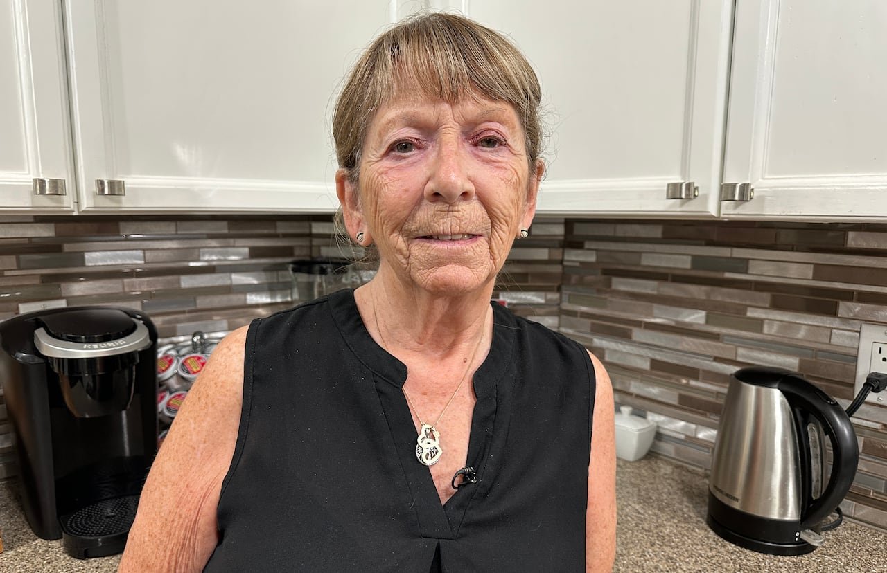 default-869 Woman standing in her kitchen.