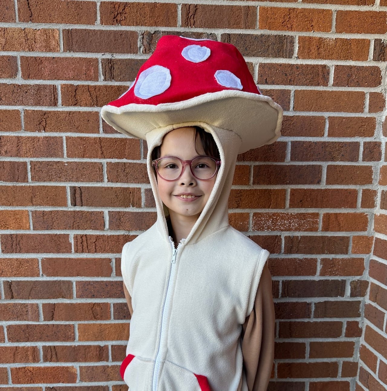 default-331 A young girl stands in a mushroom costume