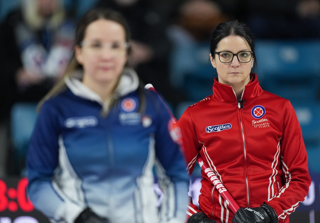 Team Canada skip Kerri Einarson, back right, stands behind Nova Scotia skip Christina Black during their playoff match at the Scotties Tournament of Hearts, in Kamloops, B.C., on Feb. 25, 2023.