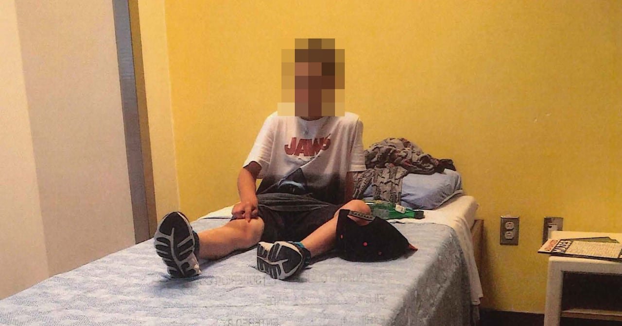 default-189 boy sits on bed